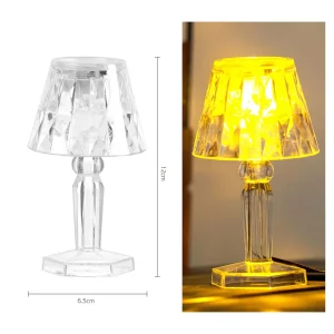 Uma elegante lâmpada de mesa transparente com luz branca morna